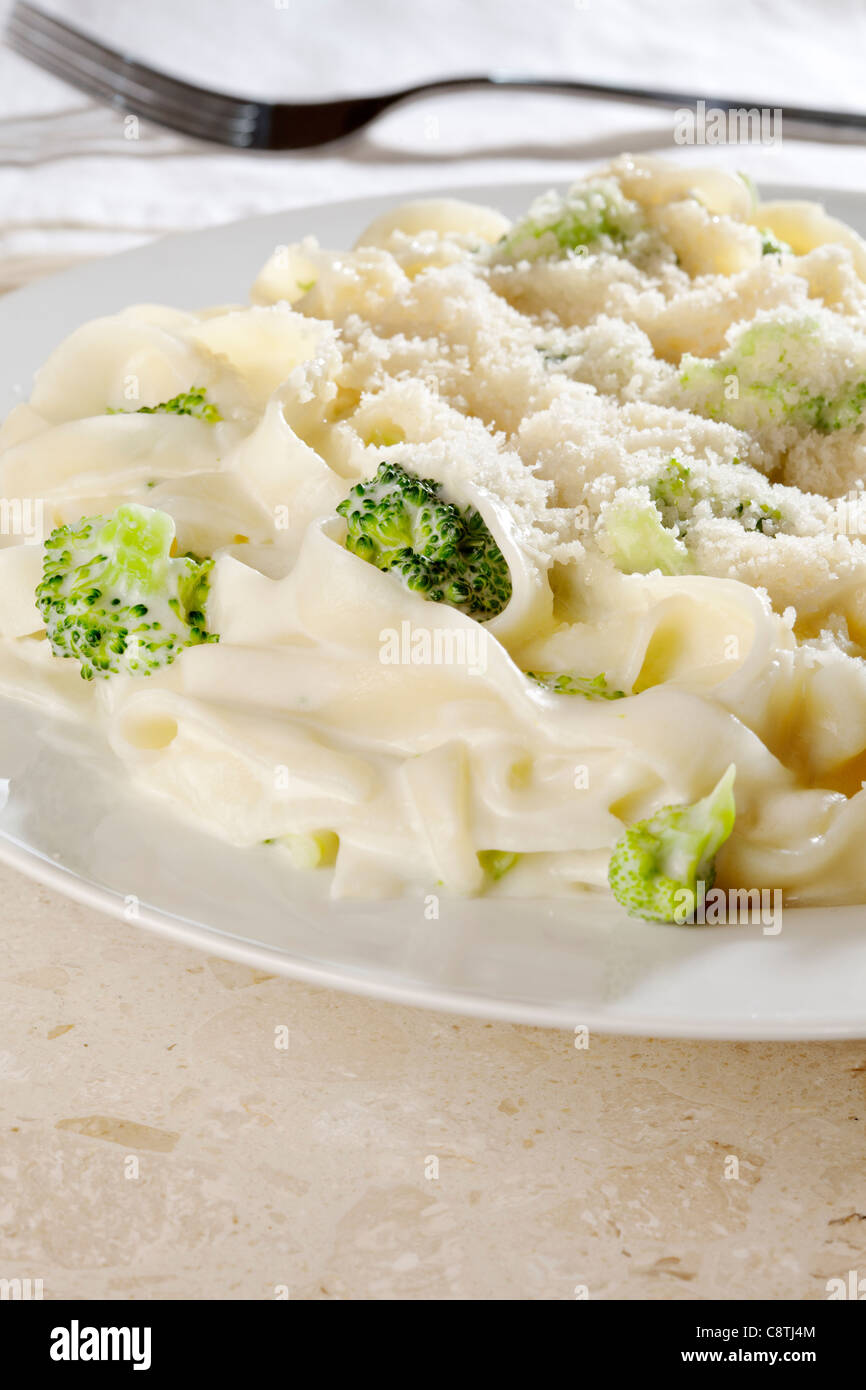 Tagliatelle e broccoli in salsa cremosa con formaggio parmigiano Foto Stock