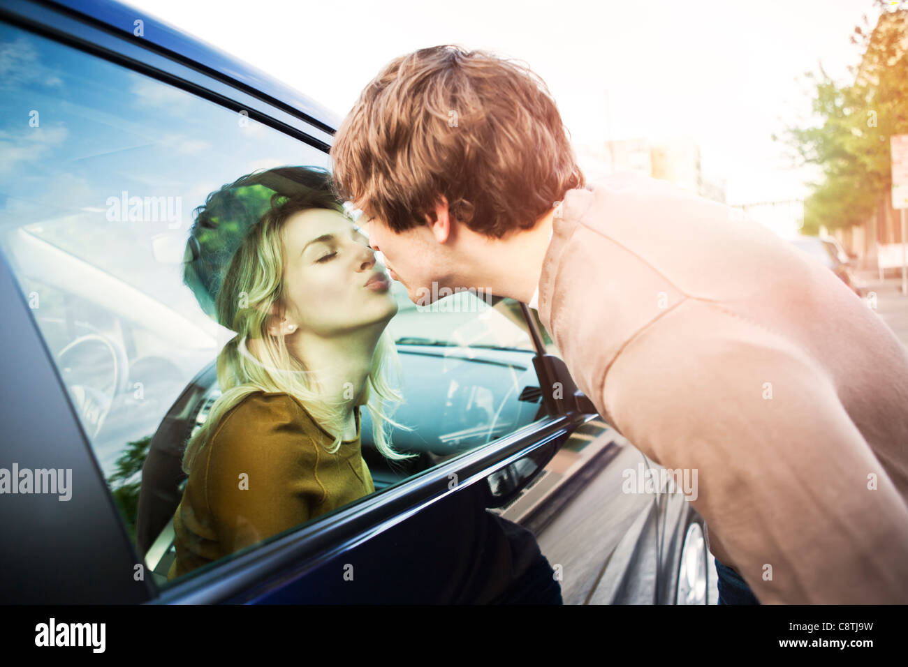 Stati Uniti d'America, Washington, Seattle, coppia giovane kissing attraverso la finestra della macchina Foto Stock