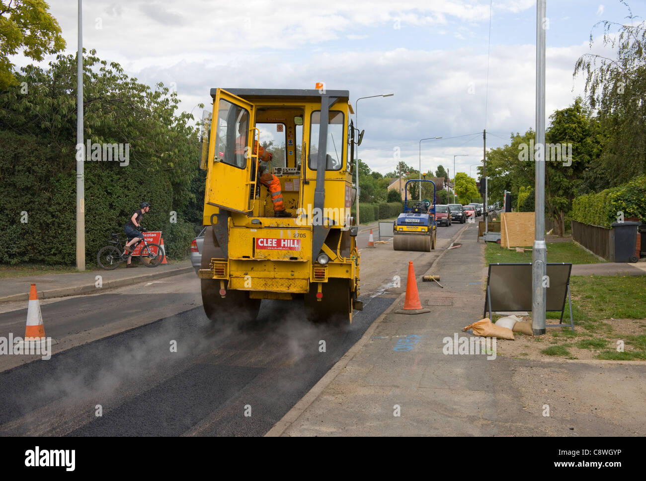 I trasporti pesanti su strada di compattazione a rullo appena di cui asfalto. secondo rullo in attesa di follow-up. Foto Stock