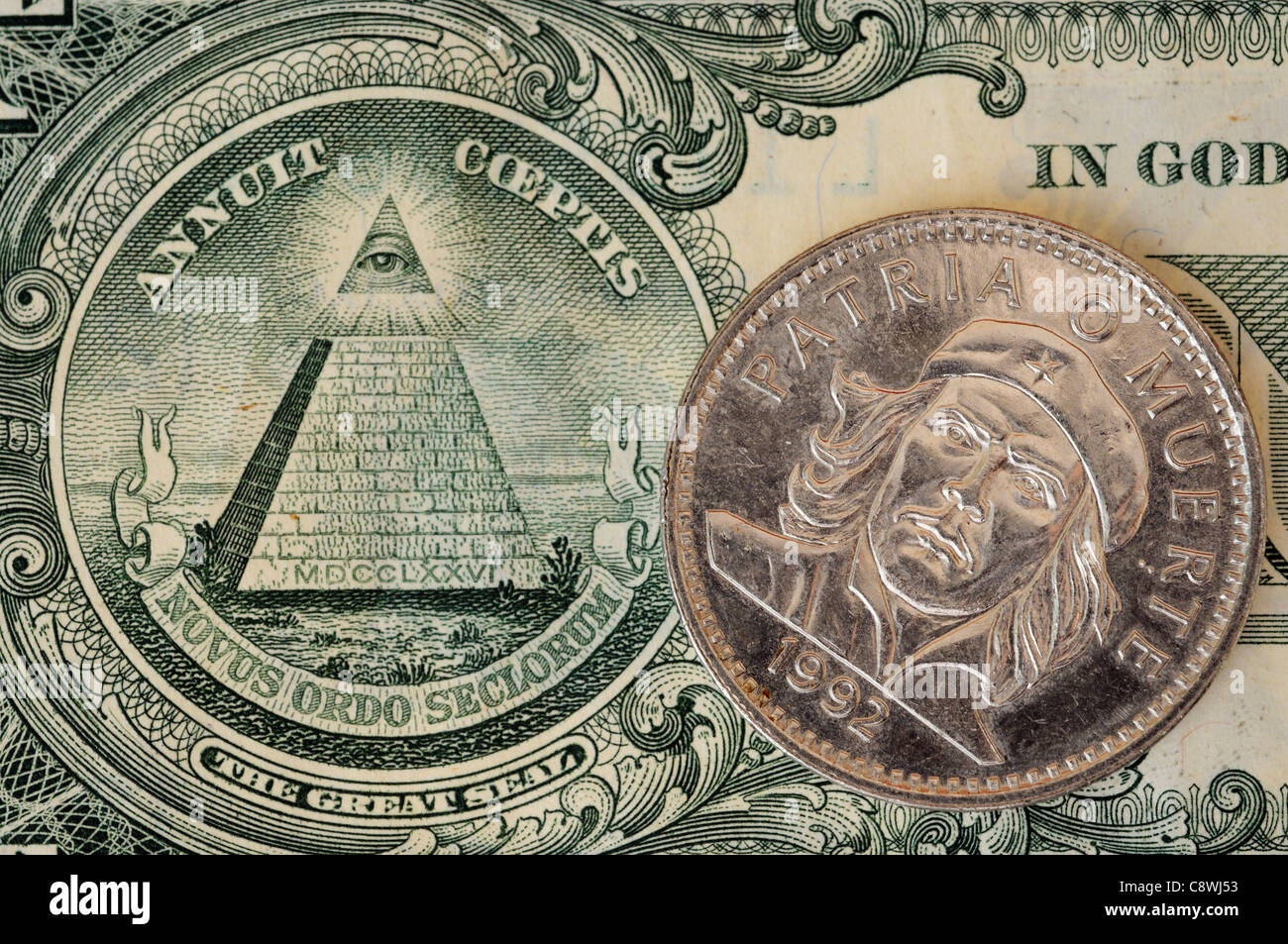 Un cubano di moneta con un ritratto di Che Guevara e di una piramide sul dollaro americano Bill Foto Stock