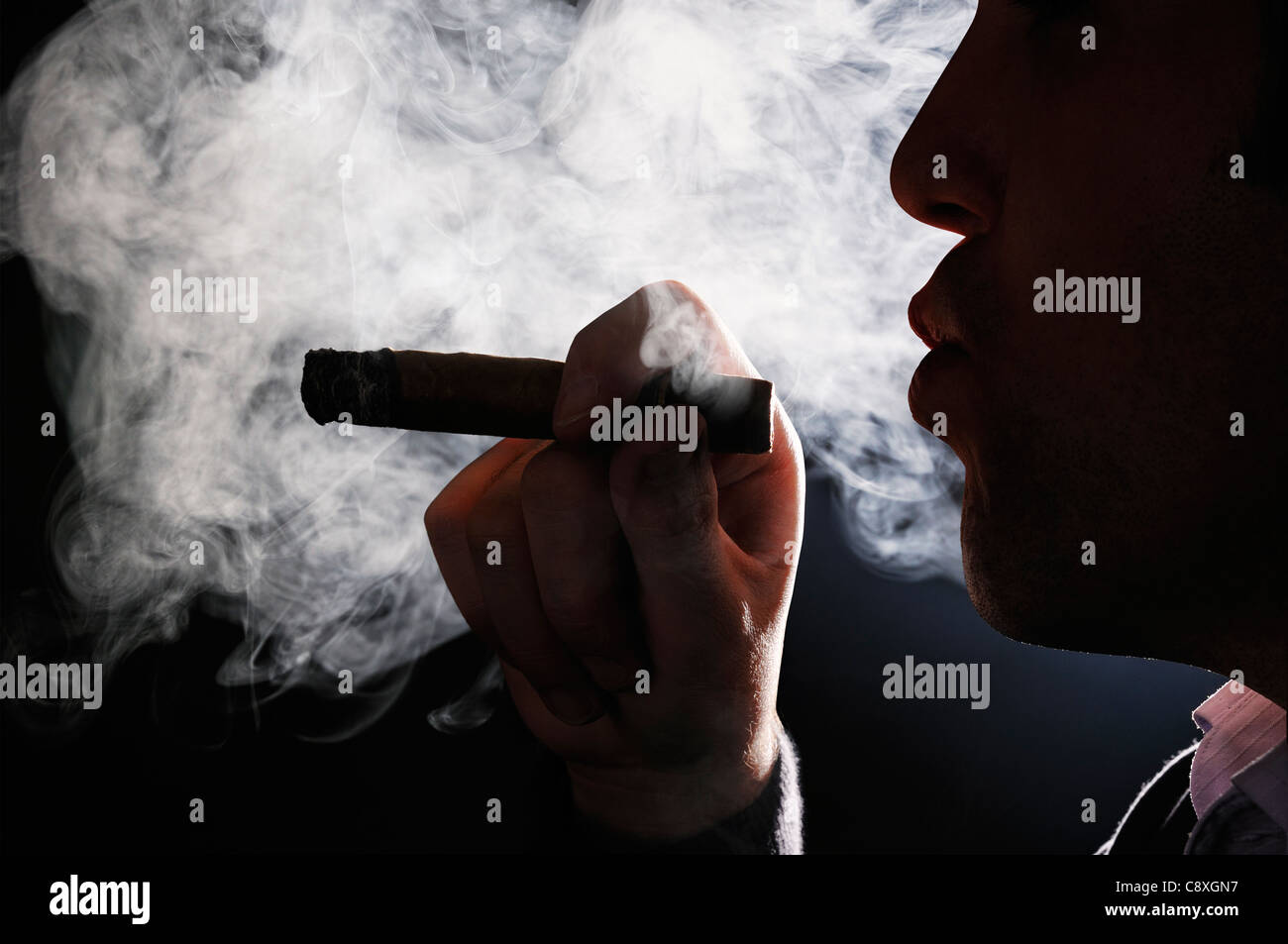 Uomo di fumare un sigaro Foto Stock