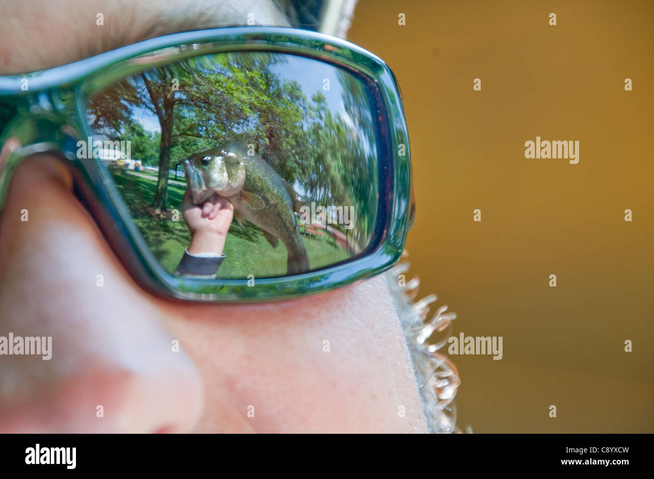 Grande bocca bass riflessa negli occhiali da sole Foto Stock