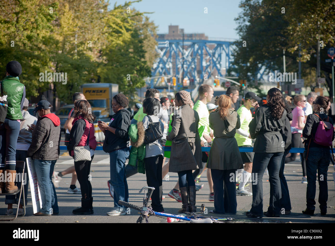 Spettatori allietare le guide sulla Quinta Avenue in Harlem durante la maratona di New York Foto Stock
