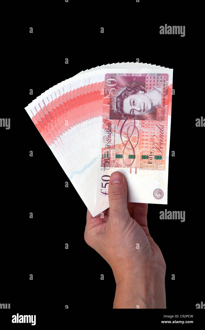 50 pound valuta britannica di banconote 50 sterline contanti detenuta in mano maschio Foto Stock