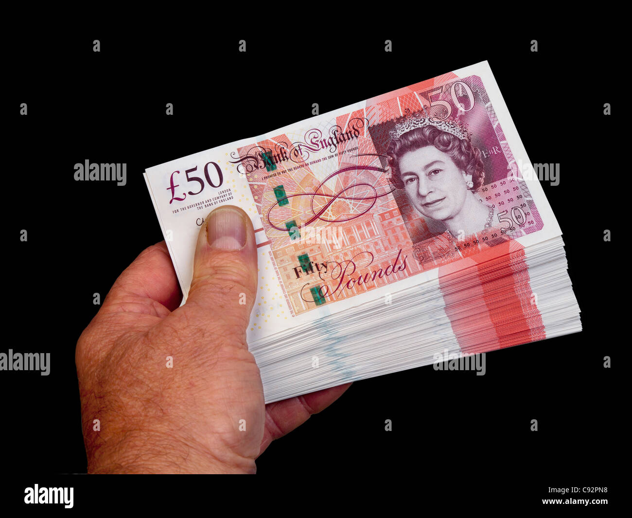 50 pound valuta britannica di banconote 50 sterline contanti detenuta in mano maschio Foto Stock