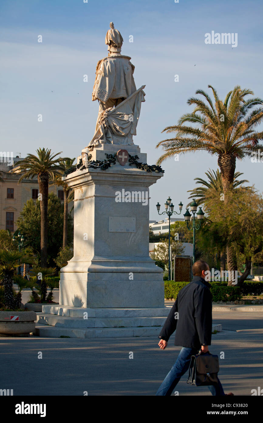 Sicilia, Italia, Europa occidentale; un uomo camminare davanti al re Vittorio Emanuele primo monumento in Trapani Foto Stock