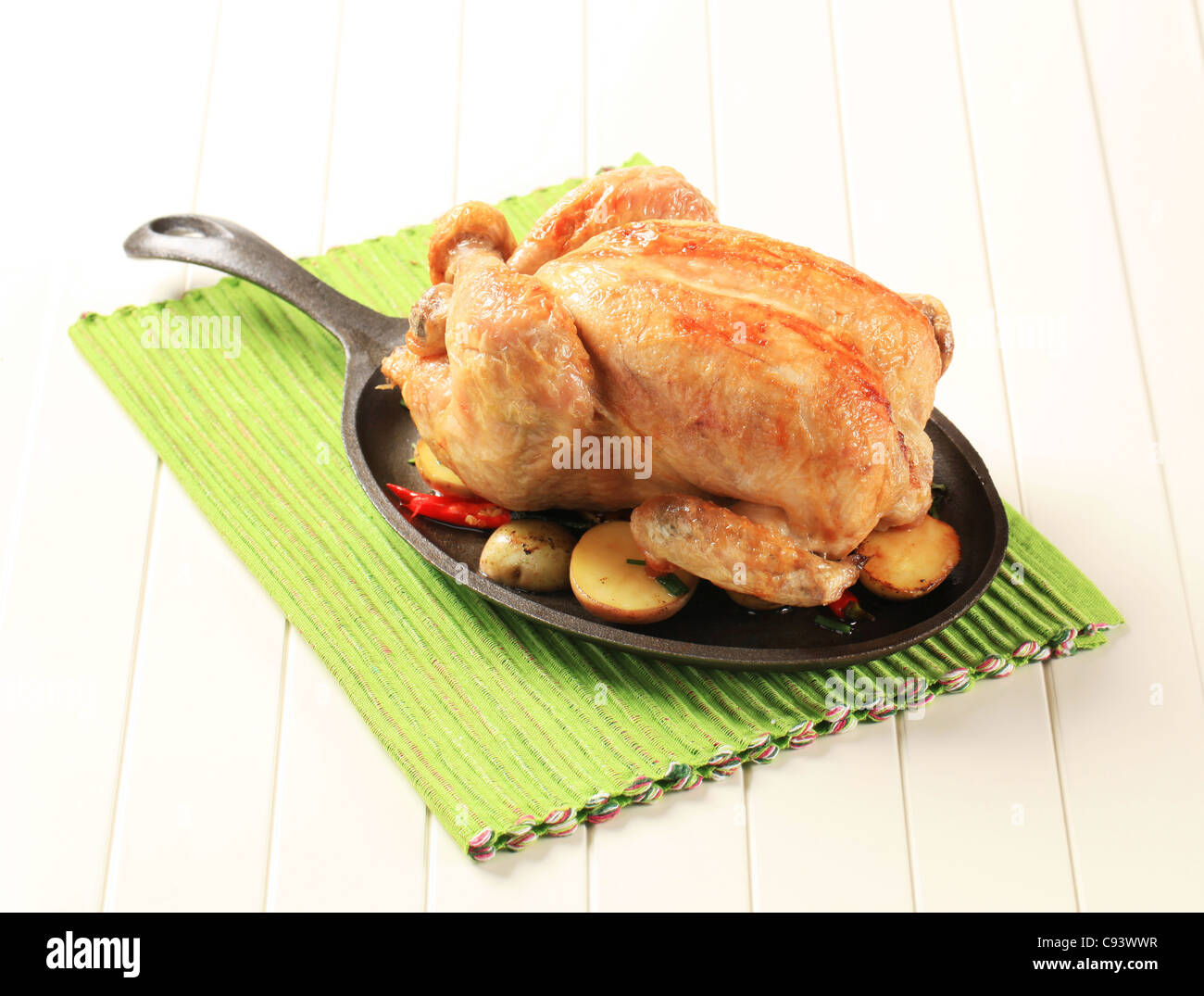 Il pollo al forno e patate su una padella in ghisa Foto Stock