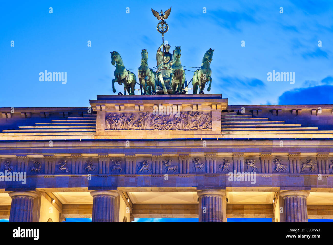 L'iconico punto di riferimento della quadriga sulla sommità del Brandenburger Tor illuminati al crepuscolo di Berlino in Germania, Europa UE Foto Stock