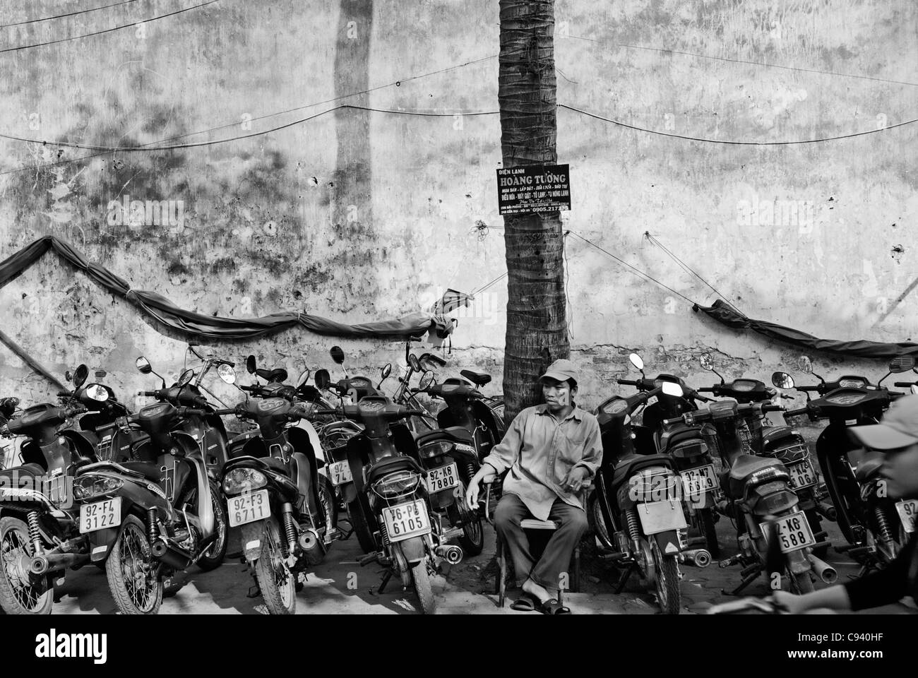 Asia, Vietnam, Hoi An. Hoi An old quarter. Parcheggio moto con un assistente. Foto Stock