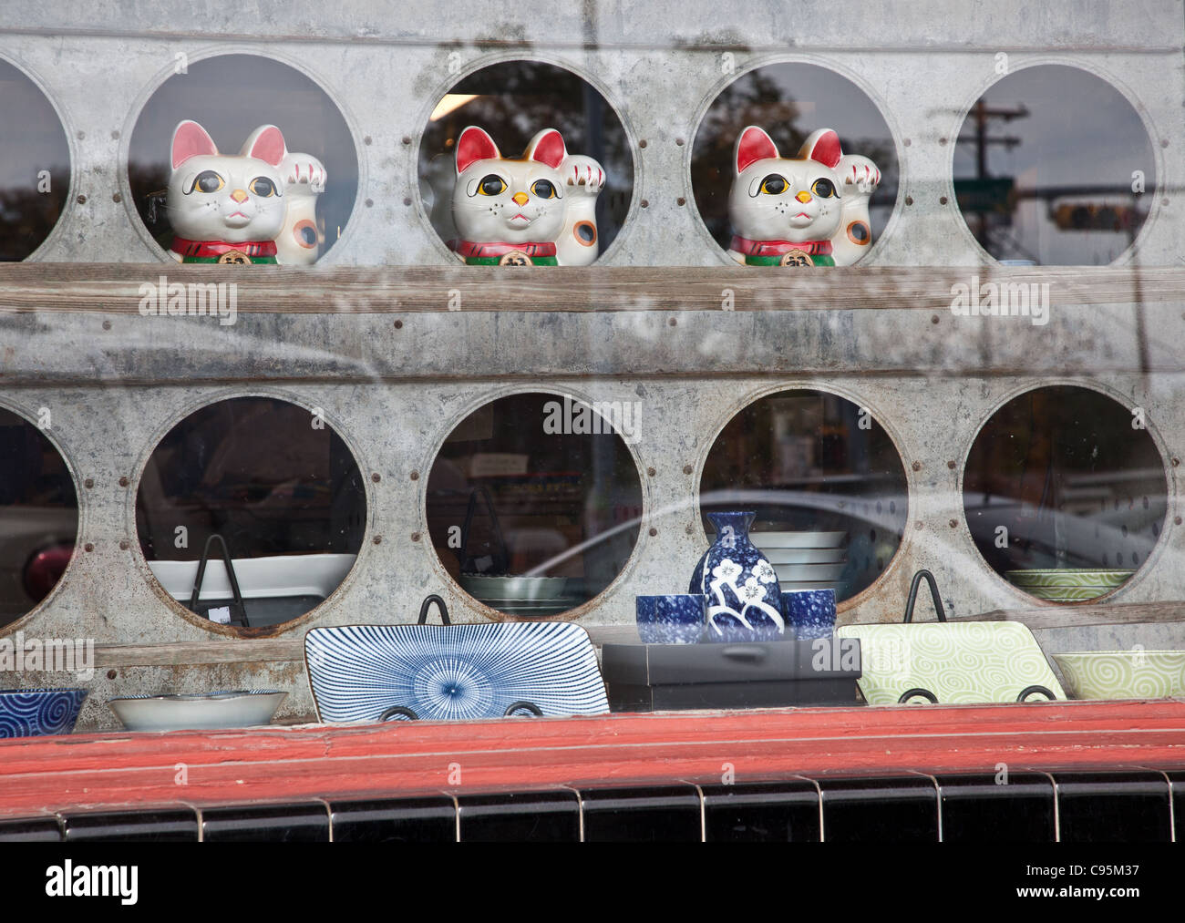Tre fortunati gatti Giapponesi in una finestra storefront di Austin in Texas Foto Stock