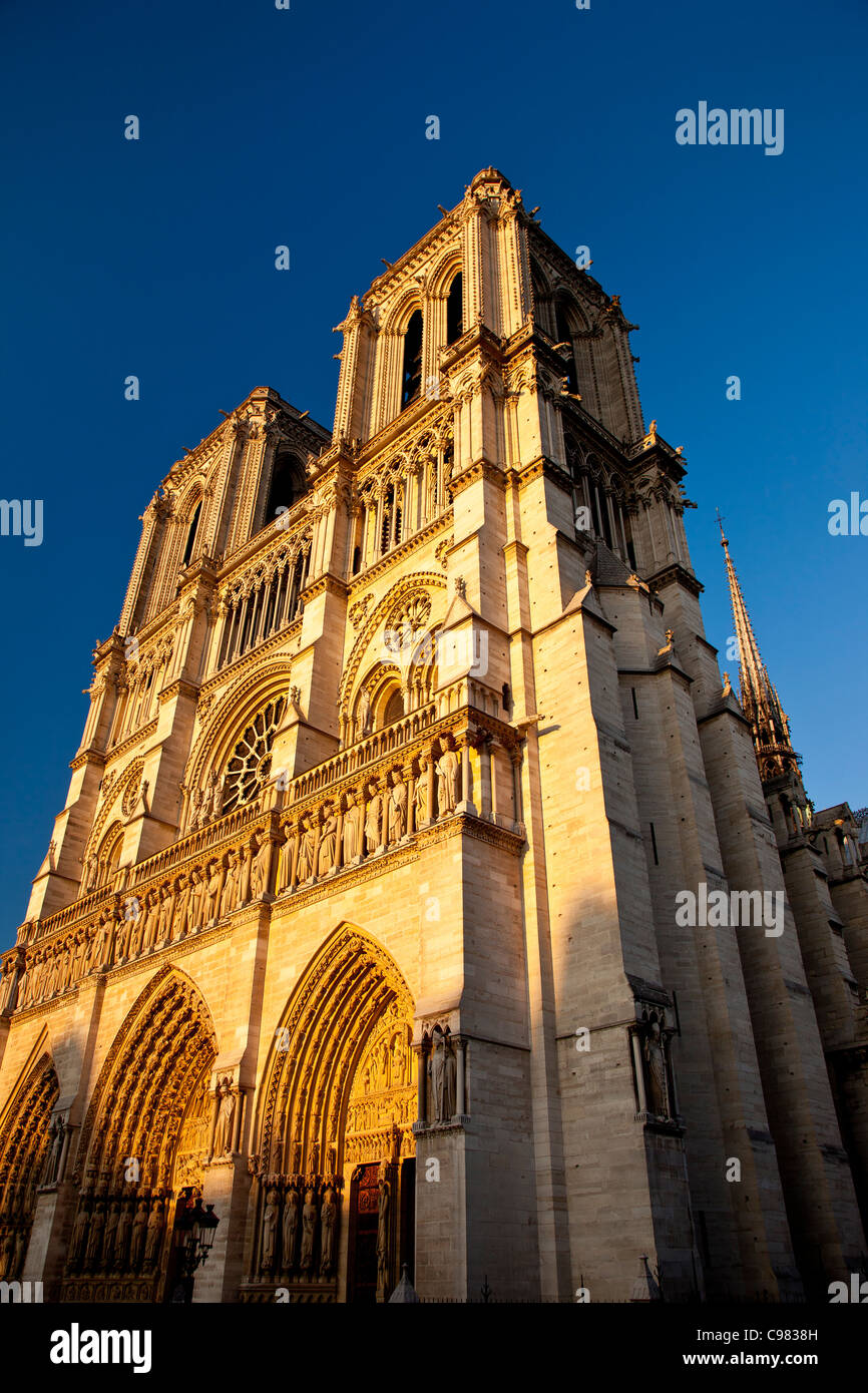 Il sole al tramonto si illumina in su le torri della cattedrale di Notre Dame di Parigi Francia Foto Stock
