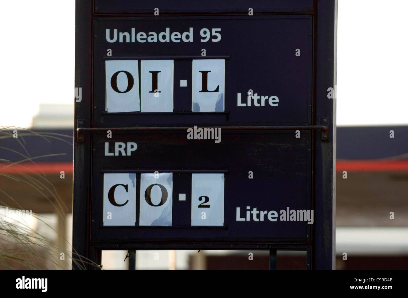 Il riscaldamento globale impatto segni pubblicati sulla stazione di benzina priceboard come si immette Swansea in Galles del Sud al posto del prezzo del carburante Foto Stock