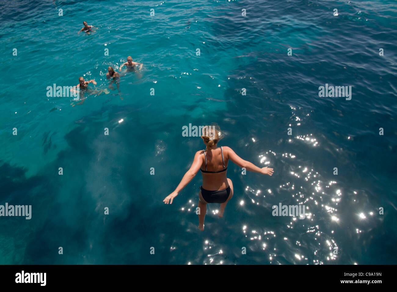 Ragazza giovane saltare in acqua di mare Maiorca Baleari Spagna Foto Stock