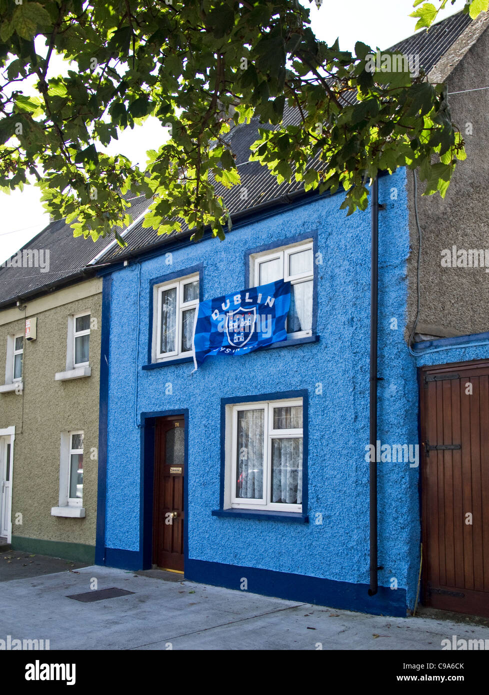 Una piccola casa decorata nei colori del Dublin Gaelic football team con la sua bandiera- Skerries, County Dublin, Irlanda Foto Stock