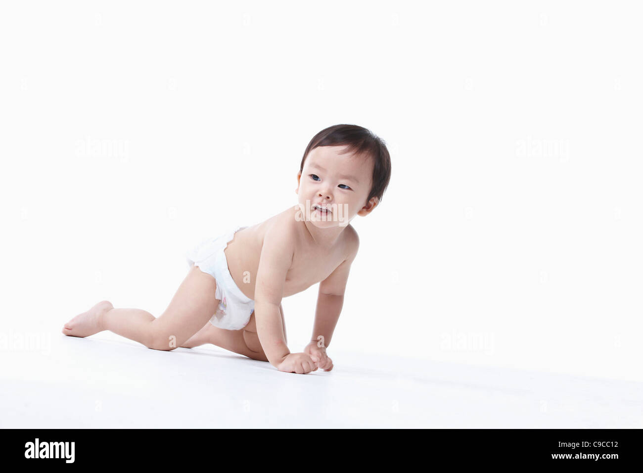 Baby boy nel pannolino gattona Foto Stock