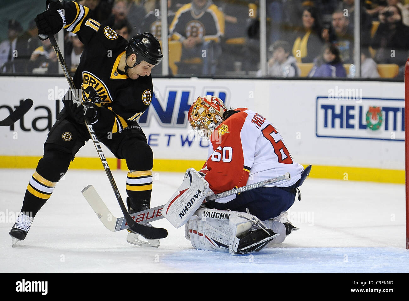 8 dicembre 2011 - Boston, Massachusetts, STATI UNITI - Centro di Boston, Gregory Campbell (#11) tenta di roba il puck per un obiettivo contro Florida Panthers Goalie, Jose Theodore (60), con nessuna fortuna nel corso del secondo periodo di gioco. I Bruins è uscito forte nel primo ma senza fortuna la ricerca sul retro della Foto Stock