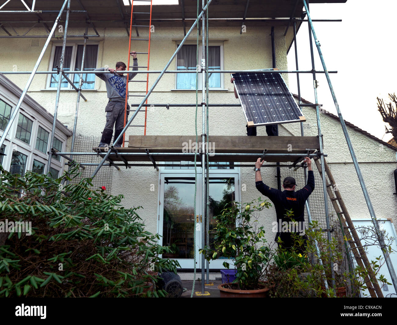 Pannelli solari essendo insalled in una casa nel Surrey in Inghilterra nel tentativo di battere il taglio in si adatta a pagamento in cui entra in vigore questa settimana dopo il 2° marzo 2012 Foto Stock