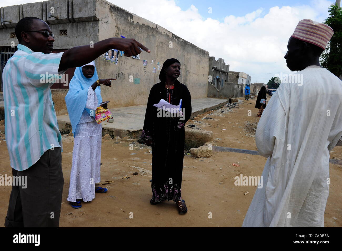 Agosto 5, 2010 - Kano, Kano, NIGERIA - Ward Kwciri persona focale Auwalu Sulaiman, centrale e sinistro in nero, Josephine Kamara, l'UNICEF di ufficiale responsabile di una mobilitazione sociale per il vaccino antipolio campagna, punto fuori per un villaggio leader religiosi, a destra nelle case di persone locali che rifiutano la pol Foto Stock