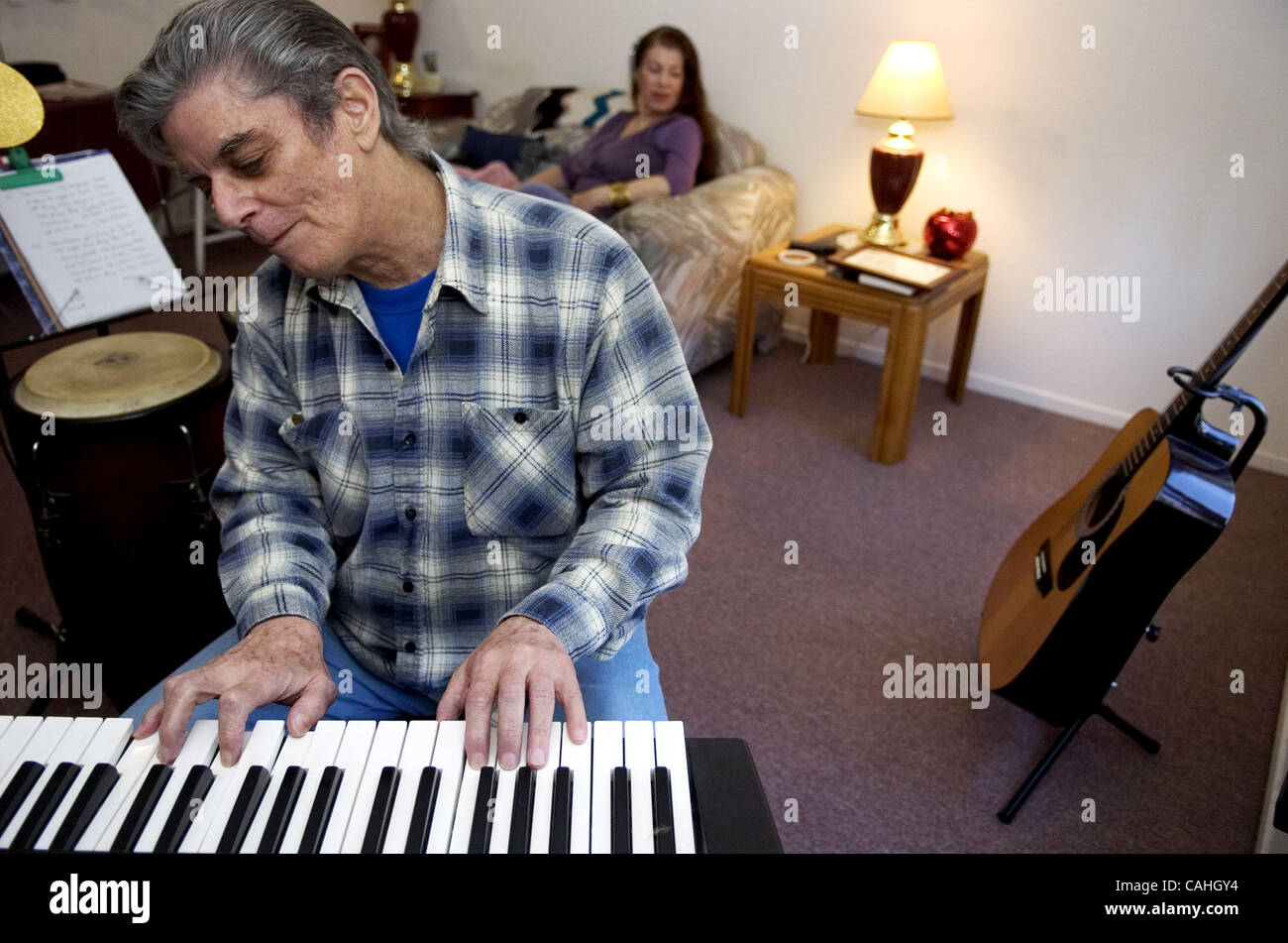Secondario: Charles sano gioca la chiave di bordo, di bongo e chitarra nonché scrive musica lirica, poesia e vernici nel suo appartamento in West Sacramento. Qui egli suona la tastiera come il suo amico Patrice Alvarez ascolta su in background. Sano ha passato una vita a promuovere ciò che egli termini ''latino-ja Foto Stock