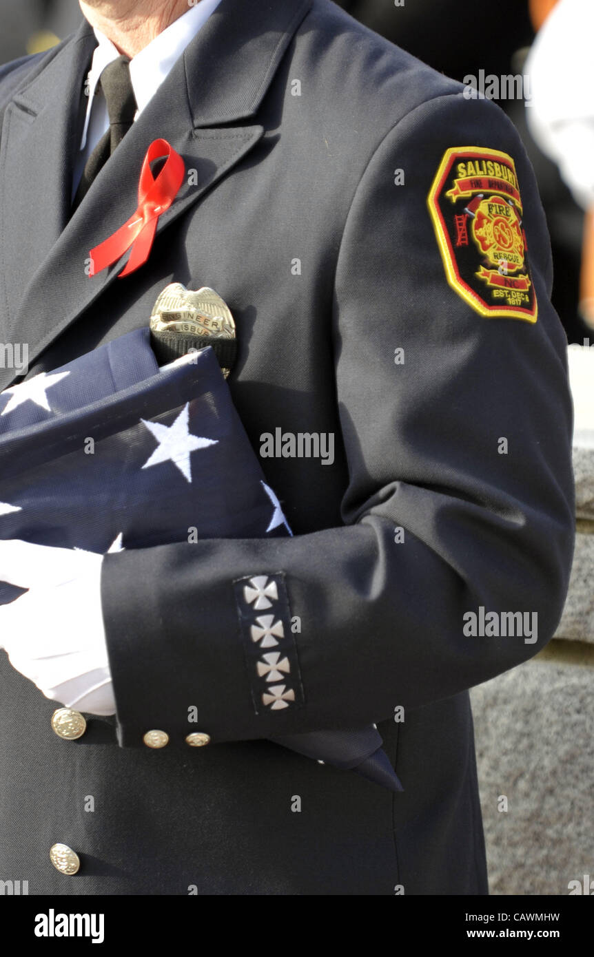 Aprile 27, 2012 - Salisbury, North Carolina, Stati Uniti d'America - 10 Marzo 2008: a Salisbury, NC pompiere tiene la bandiera americana dopo un memoriale di servizio Lunedì 10 Marzo 2007 per i due vigili del fuoco caduti, Victor Isler e Justin Monroe. (Credito Immagine: © Sean Meyers/ZUMAPRESS.com) Foto Stock