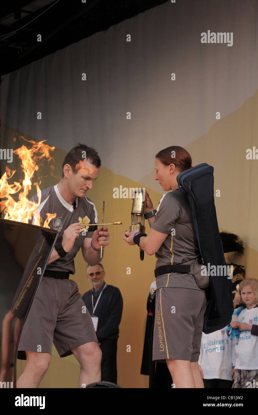 Riportando la fiamma olimpica a un Davey lampada dopo la Torcia Olimpica vicino Cattedrale di Exeter Devon UK domenica 20 maggio 2012. Foto Stock