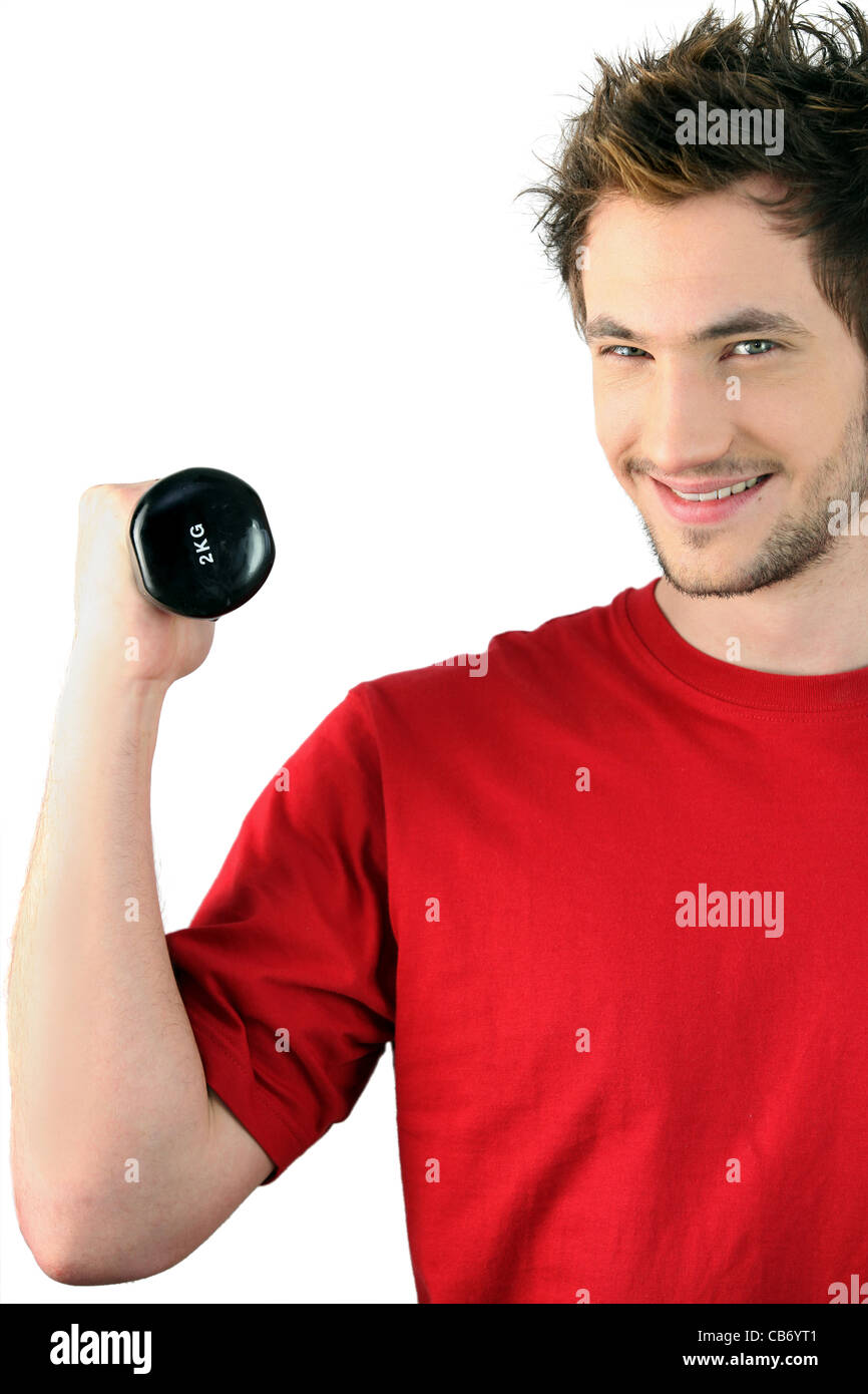 Giovane con un 2kg dumbbell Foto Stock