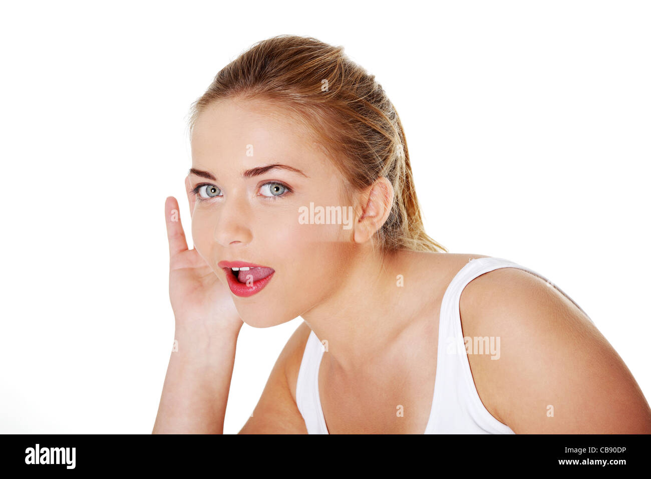 Teen donna bionda cercando di ascoltare un gossip Foto Stock