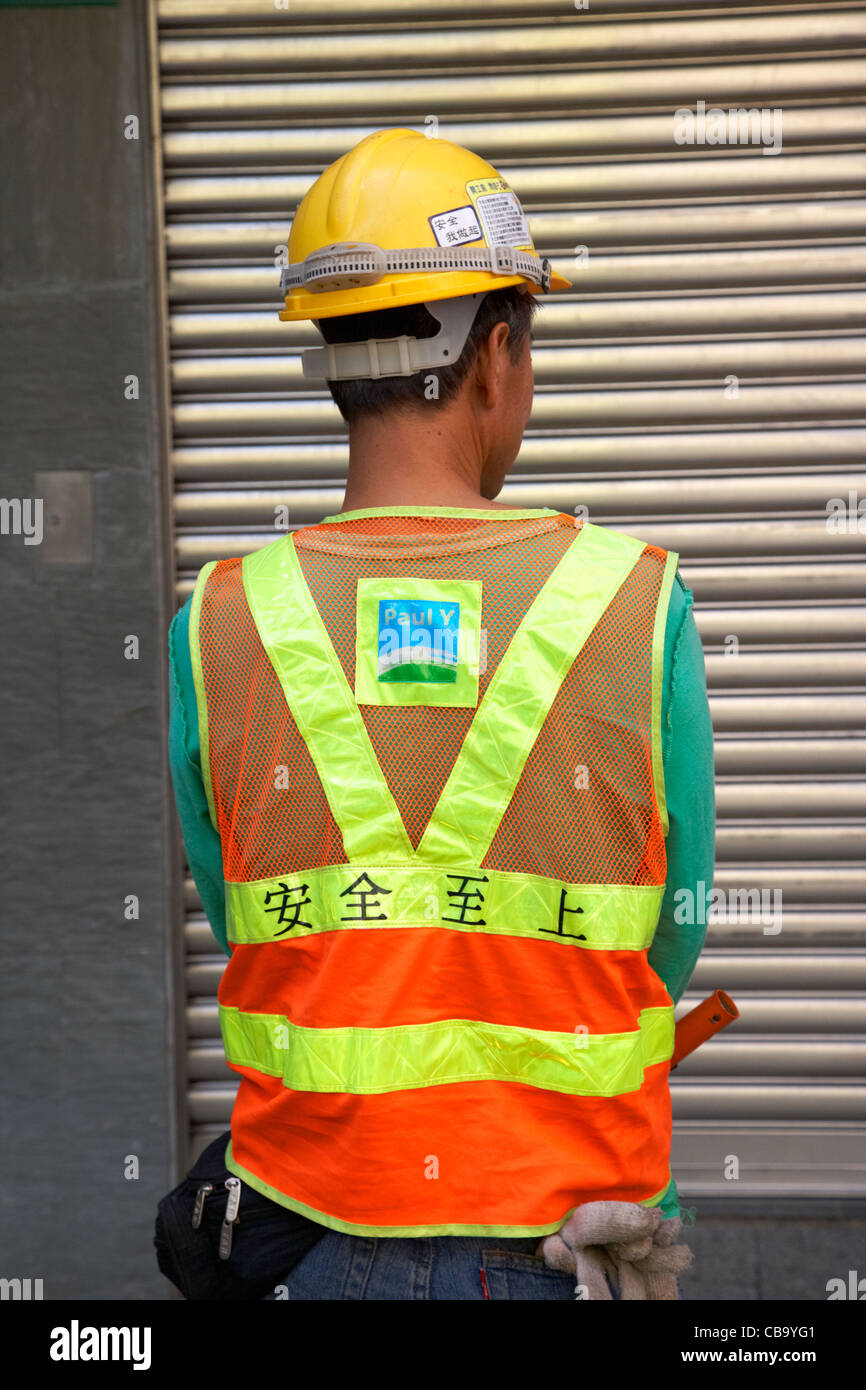 Cinese edificio di costruzione i lavoratori indossando alta vis canottiere hong kong cina della RAS di Hong Kong Foto Stock