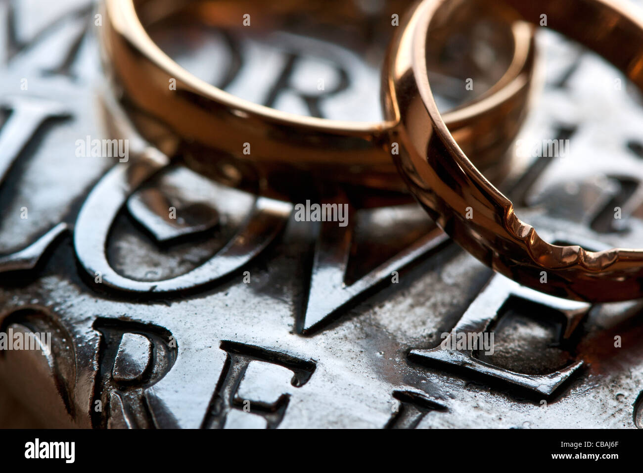 Due anelli di nozze su metallo cuore con parole di amore Foto Stock