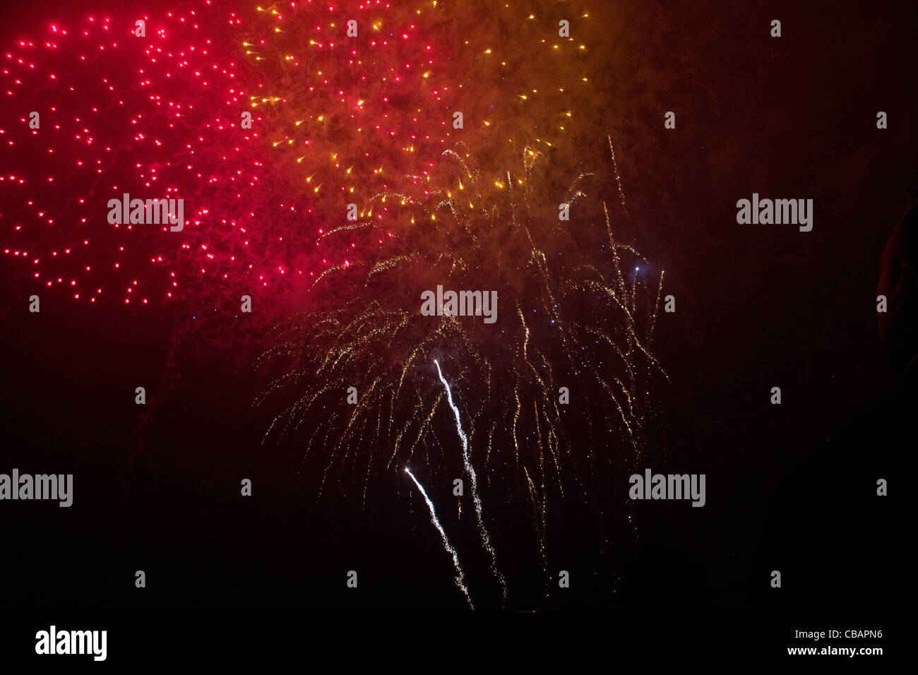 Enorme rosso e oro, fuochi d'artificio che esplodono nel cielo notturno come la nube di polvere si deposita. Londra Foto Stock