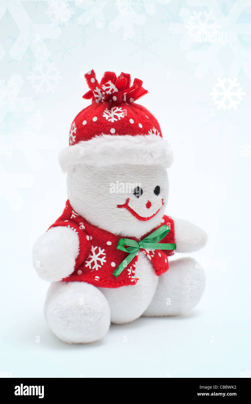 Pupazzo di neve sorridente toy vestito con sciarpa e cappuccio Foto Stock