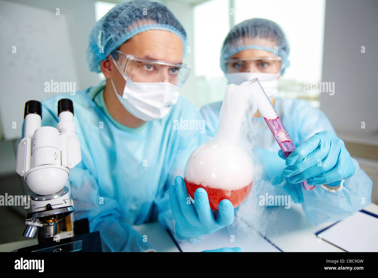 Laboratorio di compounding lavoratori due sostanze chimiche durante l'esperimento di laboratorio Foto Stock