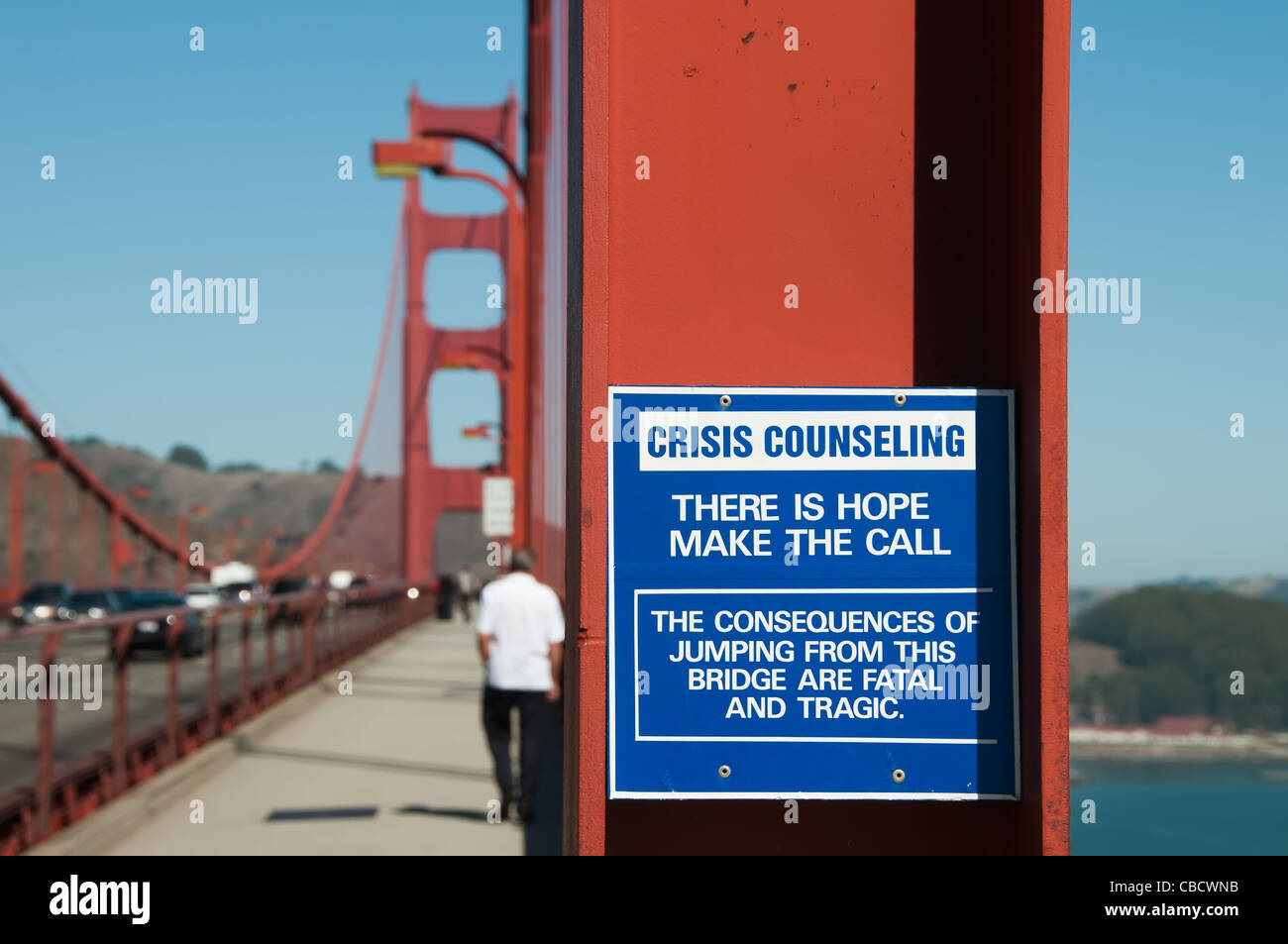 Un segno sul Golden Gate Bridge che dettaglia il Counseling di crisi, il segno legge non vi è speranza effettuare la chiamata, un uomo è a piedi Foto Stock