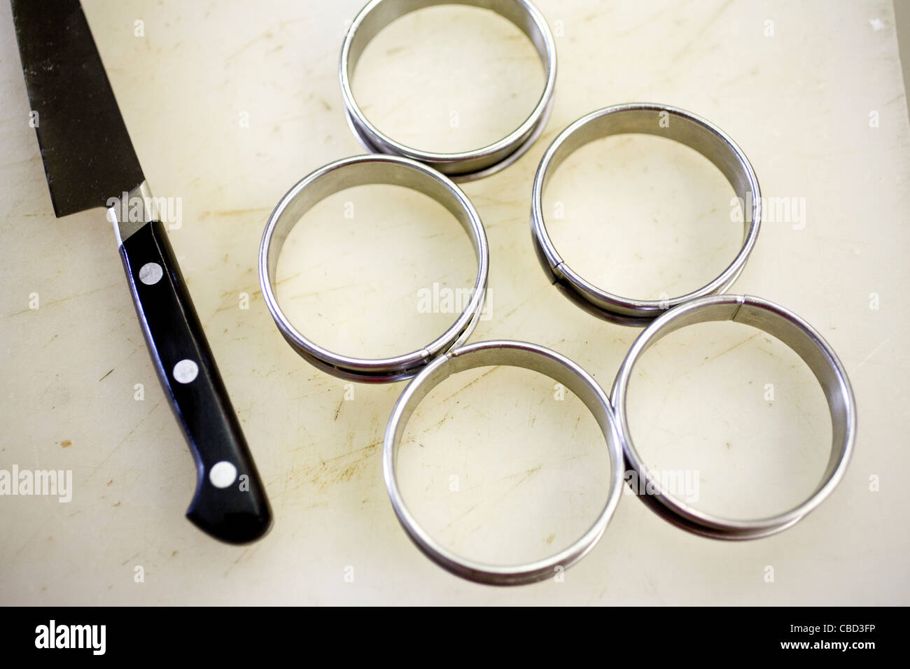 Coltello da cucina in acciaio e in acciaio inox anelli circolari utilizzati per le piastre di medicazione Foto Stock