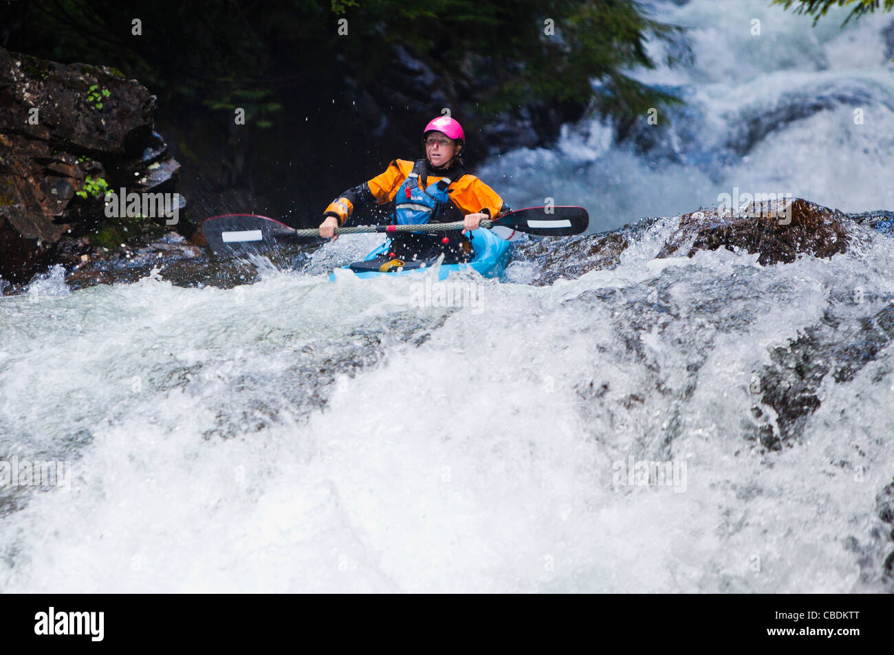 Una donna in esecuzione uno delle gocce sulla forcella centrale del fiume Snoqualmie, Washington, Stati Uniti d'America. Foto Stock