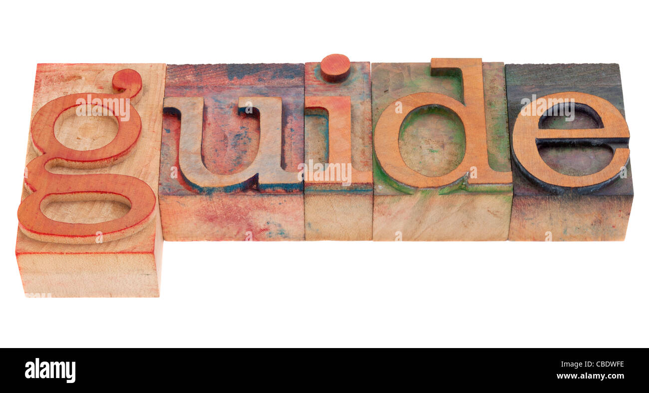 Parola di guida in legno vintage tipografia blocchi, macchiata di inchiostri a colori, isolato su bianco Foto Stock