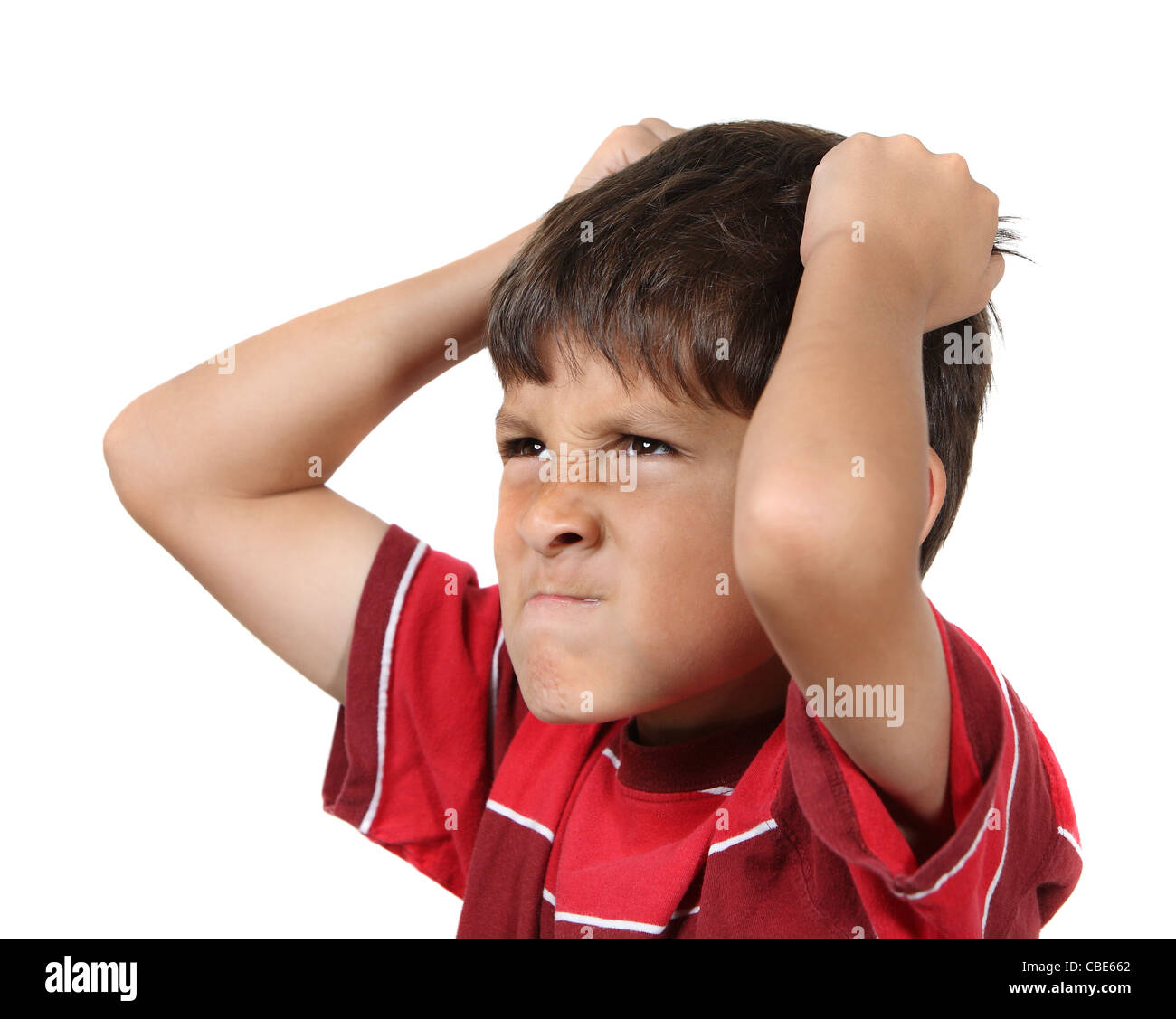 Mad o frustrato ragazzo giovane con le mani per afferrare i suoi capelli indossando maglietta rossa su sfondo bianco Foto Stock