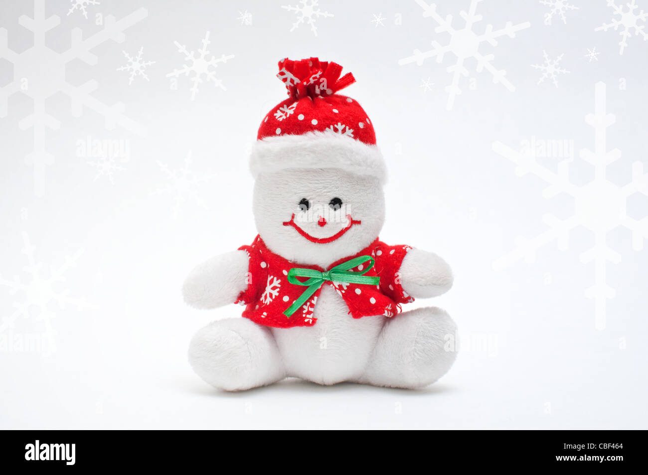 Pupazzo di neve sorridente toy vestito con sciarpa e cappuccio Foto Stock