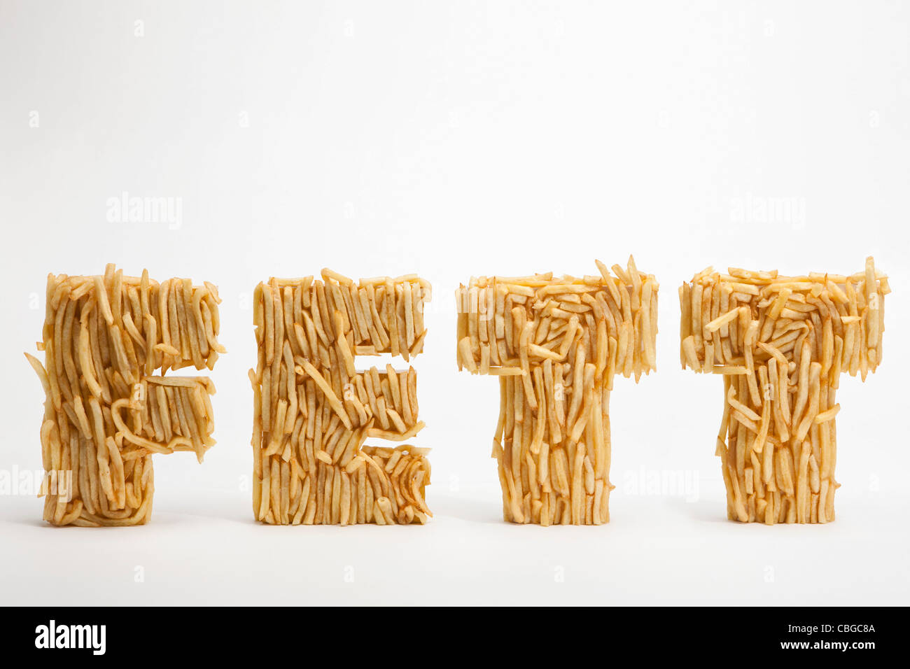 Patate fritte stampate per rendere la parola FETT, la parola tedesca per il grasso Foto Stock