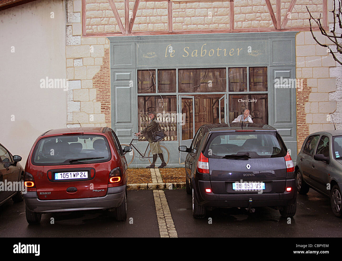 Tromp l'oeil dei calzolai negozio su una parete in Neuvic sur l'Isle, Francia. Foto Stock