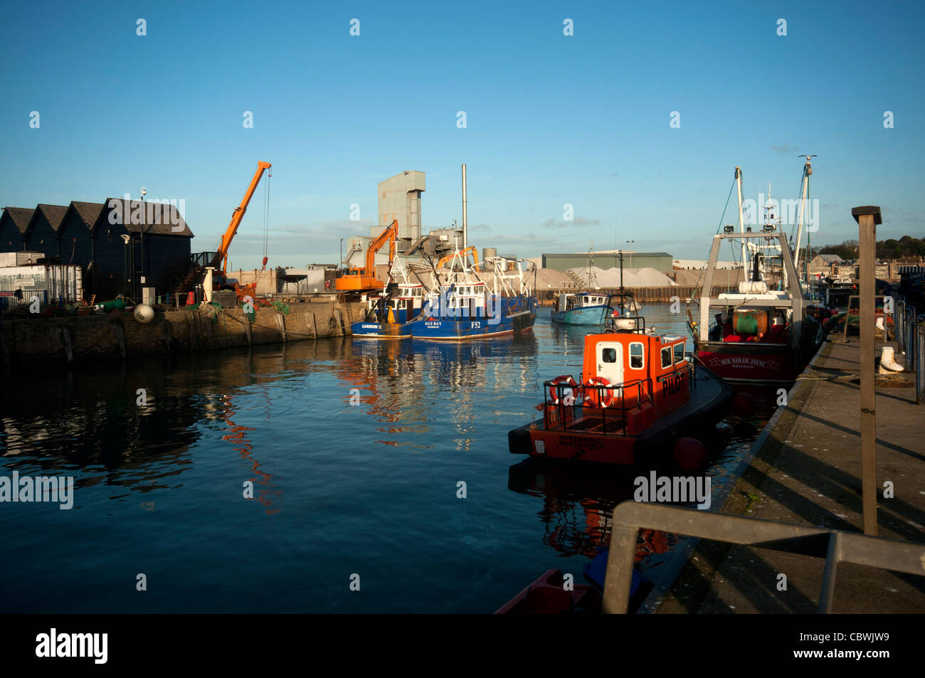 Barca da pesca di ritorno dalla pesca Pesca barche e reti nel porto di whitstable kent england Foto Stock