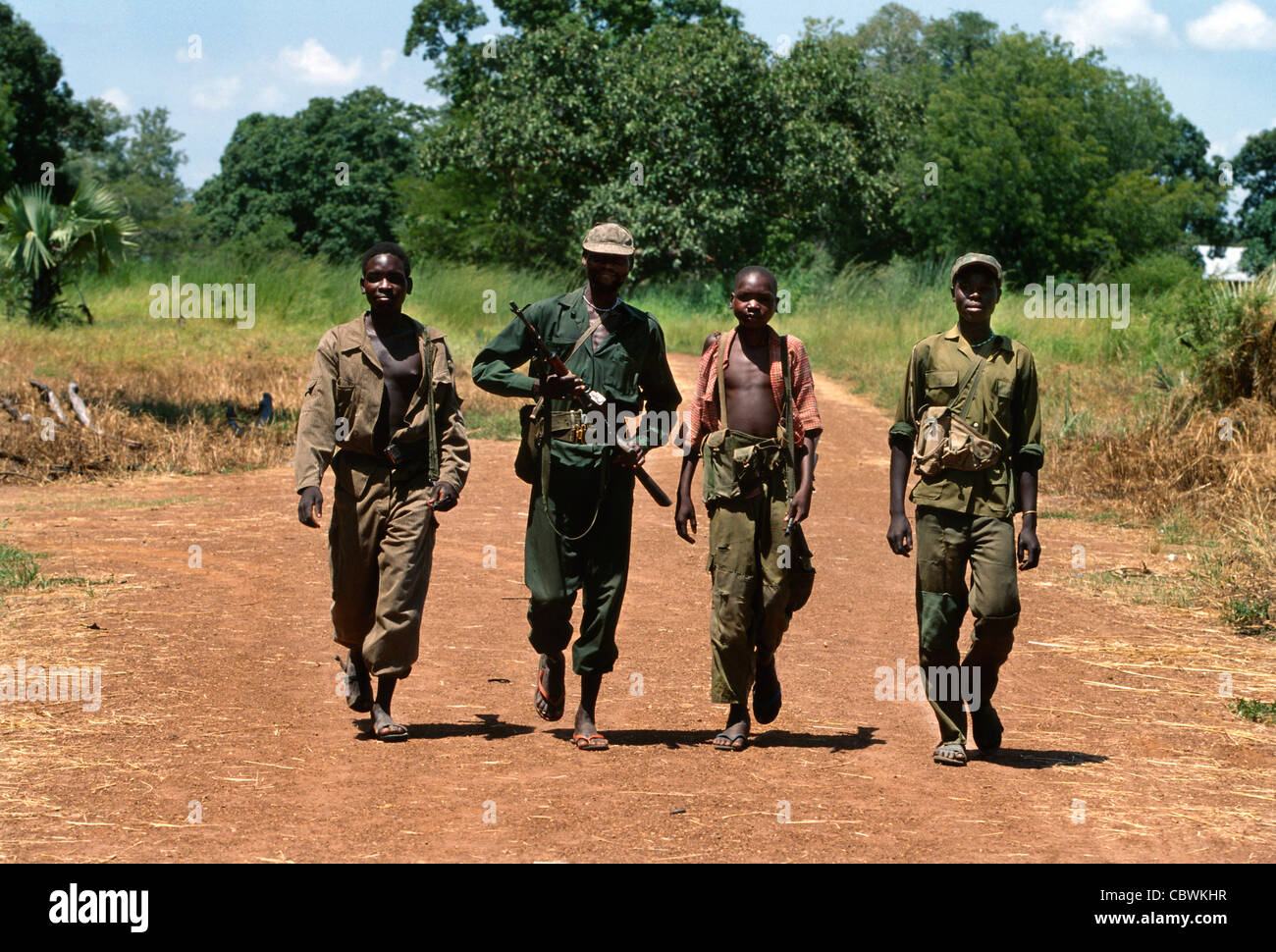 I soldati sudanesi adolescenti, membri dell'Esercito di Liberazione del Popolo Sudan, Sudan meridionale, Africa, hanno immagliato di pattugliare un'area remota vicino a Yei, nel 1997 Foto Stock