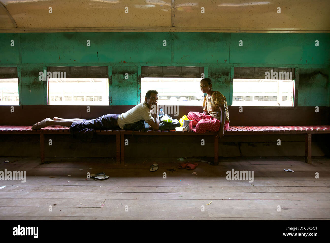 Due passeggeri all'interno del treno vuoto auto in Yangon, Myanmar Foto Stock