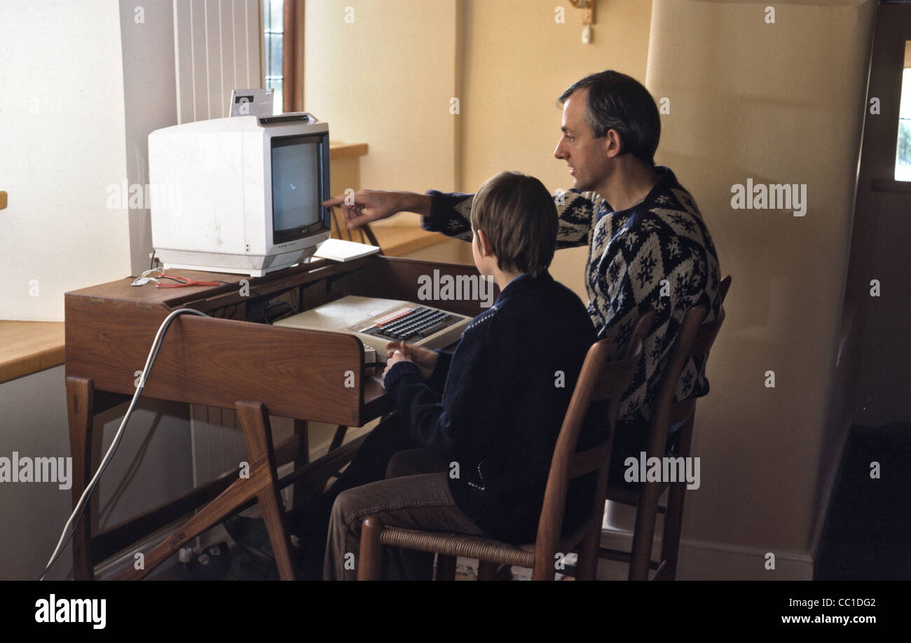 Padre e figlio giocando su uno del primo home computer chiamato Archimedes Acorn Foto Stock