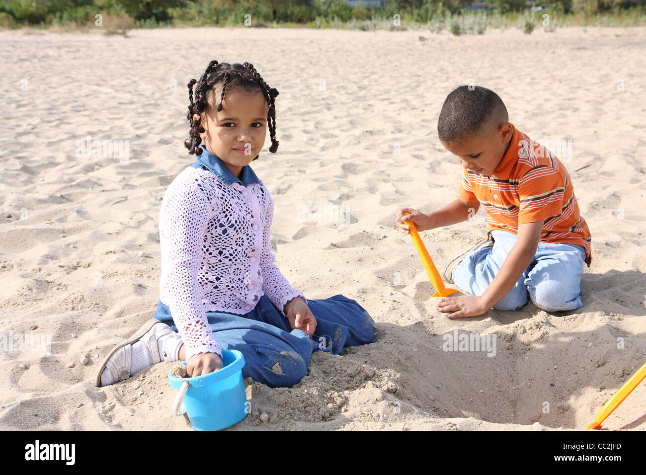 Bambini, un ragazzo e una ragazza a giocare nella sabbia Foto Stock