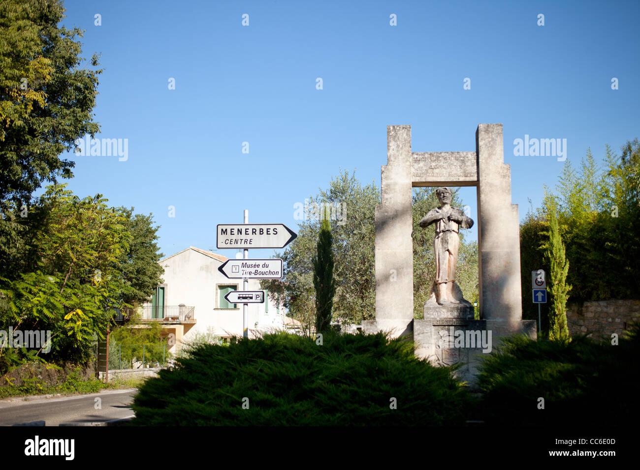 Una statua di pietra sul lato della strada che conduce nella città di Menerbes, Francia Foto Stock