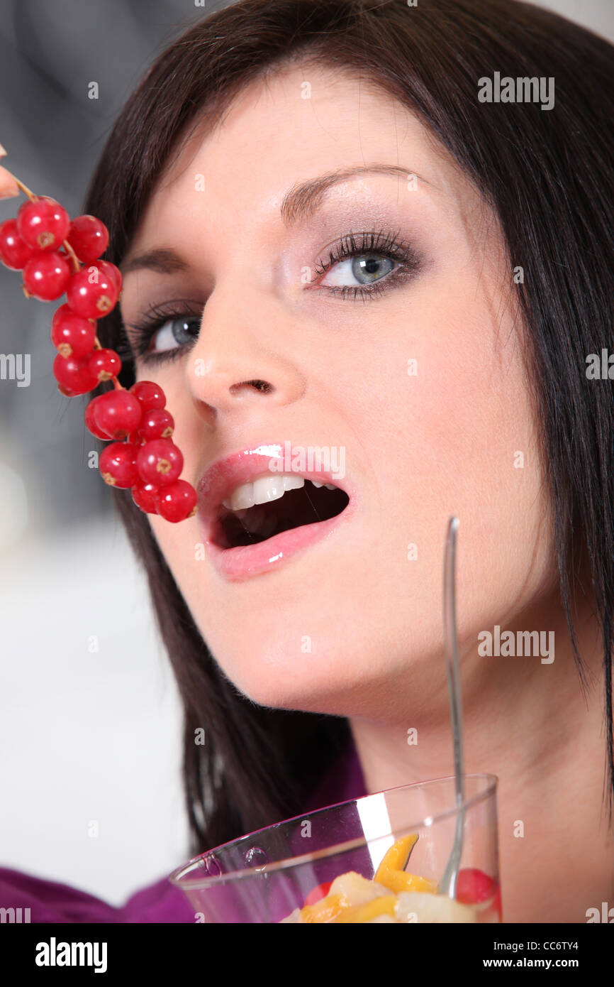 Donna mangiare bacche Ribes Foto Stock
