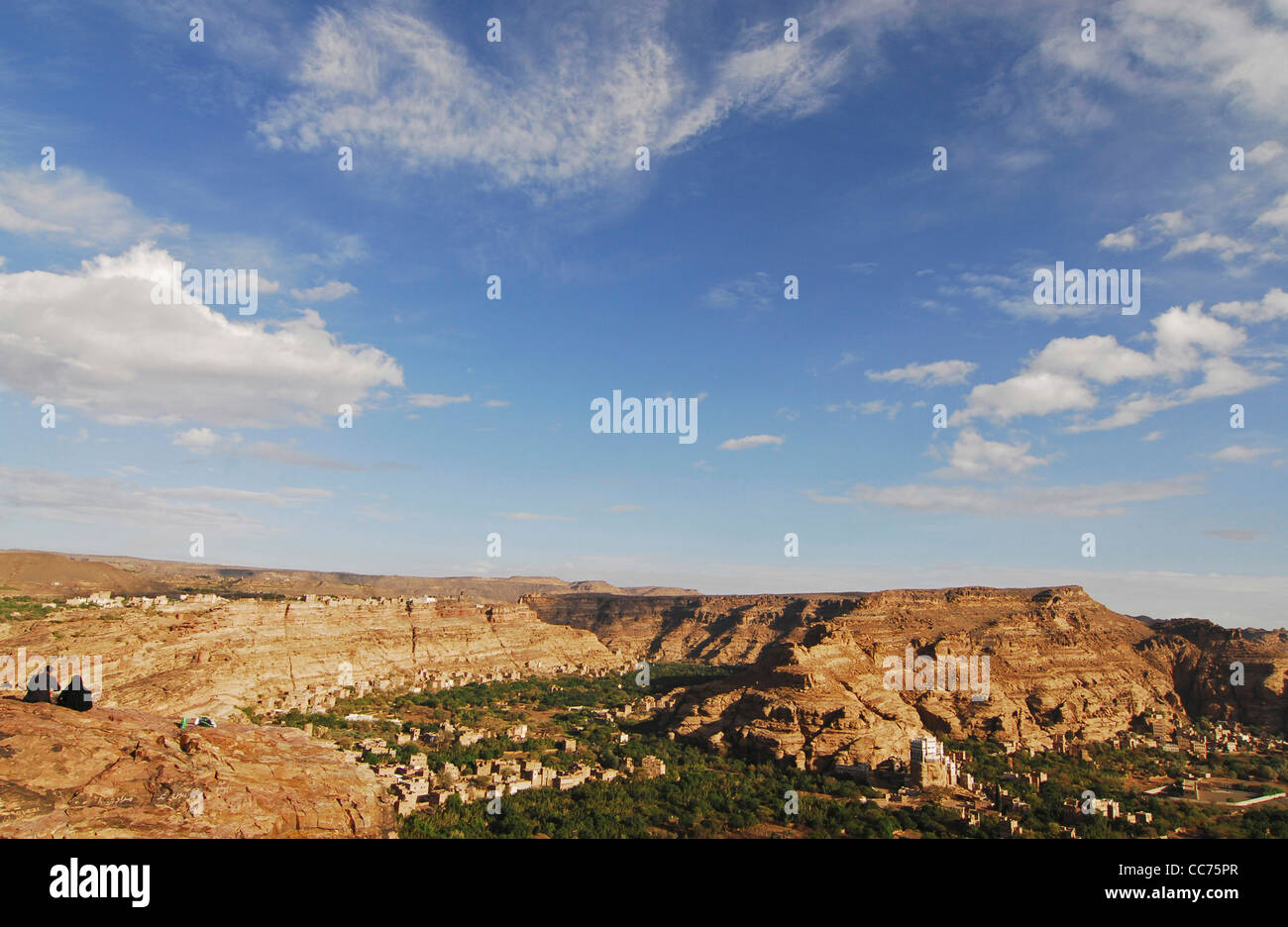 Yemen, Wadi Dar, la vista di un uomo e di una donna sulla scogliera che affaccia sulle montagne Foto Stock