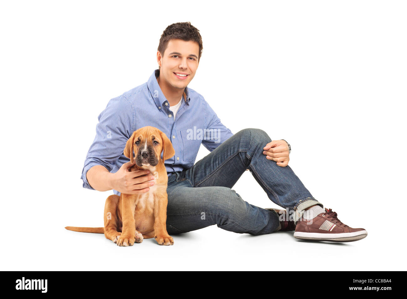 Giovane con un cane corso cucciolo Foto Stock