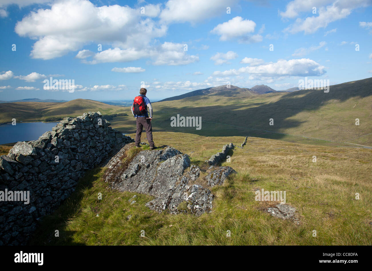 Walker guardando verso l'alto Mournes da Pigeon Rock Mountain, Mourne Mountains, County Down, Irlanda del Nord. Foto Stock